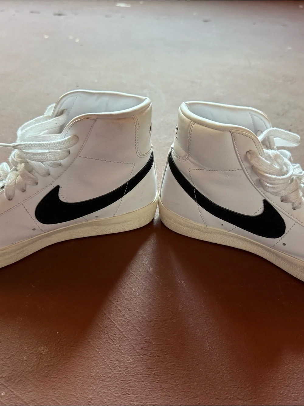 Nike White High-Top Sneakers with Black Swoosh